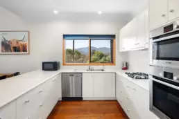 The kitchen area at 215 Mt Buffalo Pool House. This is a family friendly and pet friendly accommodation option in Porepunkah.