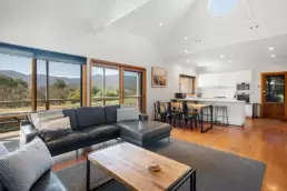 A photo of the lounge, dining and kitchen areas at 215 Mt Buffalo Pool House. This is a family friendly and pet friendly accommodation option in Porepunkah.