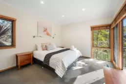 The main bedroom at 215 Mt Buffalo Pool House, showing a photo on the wall of a fox. 215 Mt Buffalo is a family friendly and pet friendly accommodation in Porepunkah.
