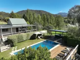 An aerial shot of the house and pool area at 215 Mt Buffalo Pool House. Family friendly and pet friendly accommodation in Porepunkah.