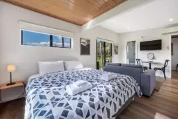 King sized bed, lounge & dining area at Feathertop Cottage, at Dreaming of the Buckland, accommodation in the Buckland Valley